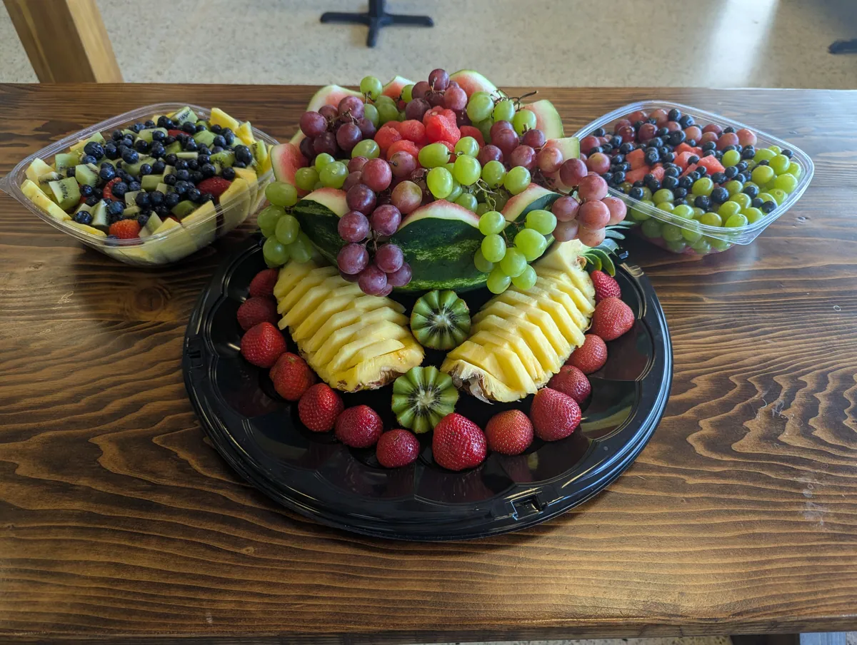 Large catering fruit spread with watermelon, pineapple, grapes, strawberries, and blueberries